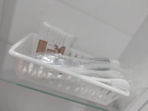 a plastic dish drying rack with a towel and a sink at Квартира посуточно in Kokshetau