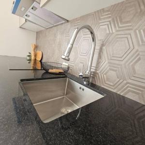 a sink in a kitchen with a counter top at [Trendy Suite] Centro città + Garage in Cuenca