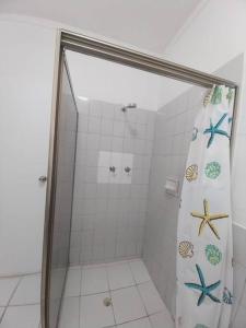 a bathroom with a shower with a glass door at Harbour View House at Point Cruz, Honiara in Honiara
