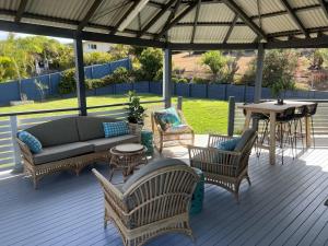 a patio with a couch and chairs and a table at Keppel 180 in Yeppoon