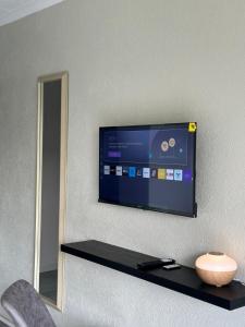 a flat screen tv hanging on a wall at SUumthing Private GuestHouse in Lebowakgomo