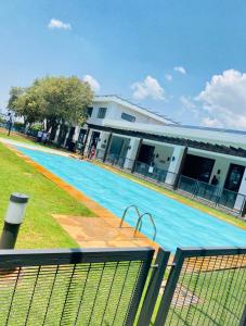 a building with a swimming pool in front of a building at A little sanctuary in Edendale