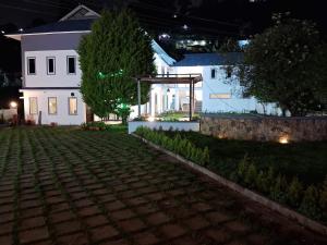 a house at night with a cobblestone yard at Magizham Homestay in Kodaikānāl