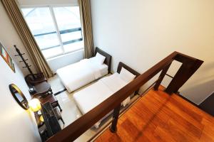 a living room with two white couches and a window at Intercity Seoul Hotel in Seoul