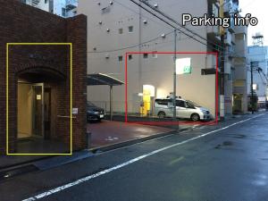 a car parked in a parking lot next to a building at Dai3Kuboi - 1 BR for 4 ppl mins walk to Peace Park in Hiroshima