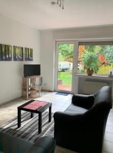 a living room with a couch and a table at Ferienwohnungen mit Parkplätzen in Oberhausen