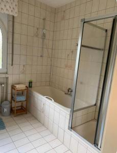 a bathroom with a shower and a bath tub at Ferienwohnungen mit Parkplätzen in Oberhausen