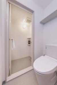 a bathroom with a toilet and a walk in shower at HOTEL NEXUS Hakata Sanno in Fukuoka