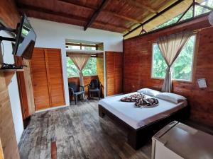 a bedroom with a bed and a tv in it at Ecogreen Hotel - San Cipriano in San Cipriano