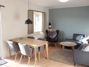 a living room with a table and a couch at 4 person holiday home in R nne in Rønne