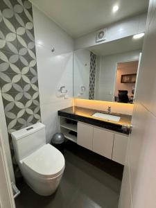 a bathroom with a white toilet and a sink at ENCALADA 1233 LUXURY APARTS NEXT TO USA EMBASY - Surco in Lima