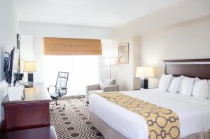 a hotel room with a bed and a desk at Baymont by Wyndham Delavan Near Lake Geneva in Delavan