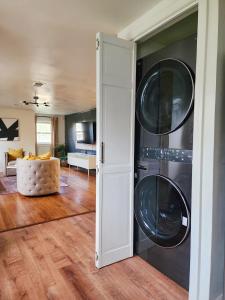 a living room with a washer and dryer at Chic Spacious Apt Near Attractions/Food/EWR/NYC in West Orange