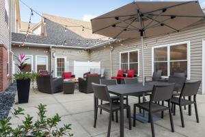 a patio with a table and chairs and an umbrella at Residence Inn Mobile in Mobile +22 photos