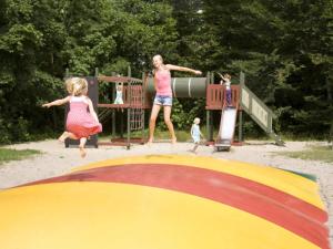 dos niñas jugando en un patio de juegos en 4 person holiday home in Hasle, en Hasle