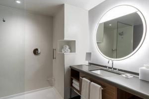 y baño con lavabo, espejo y ducha. en Courtyard by Marriott Modesto North, en Modesto