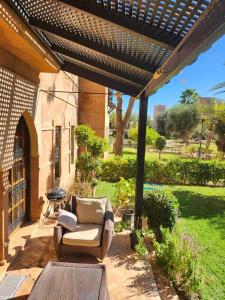 a patio with a couch and a pergola at Charming villa: serenity and style in Marrakesh