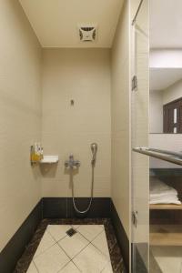 a bathroom with a shower with a glass door at Shante Hotel Shitou in Lugu