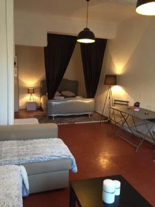 a living room with a bed and a table at Studio Calendal in Cassis