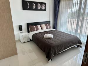 une chambre avec un grand lit et une fenêtre dans l'établissement Laguna Beach Resort 3 Condominium, à Jomtien Beach 83 autres photos