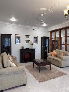 a living room with two couches and a fireplace at GG in Imphal