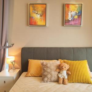 a teddy bear sitting on top of a bed at seaview beach 4-13pax CIQ 5mins johor bahru KSL MIDVALLEY in Johor Bahru