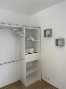 a white closet with white shelves and a refrigerator at Gîte la Chotinière in Mareuil-sur-Cher +6 photos