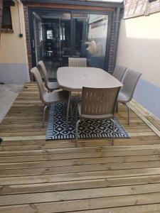 una mesa y sillas sentadas en una terraza en La Belle Evasion, en Gamaches