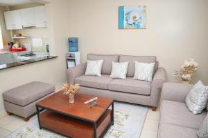 a living room with a couch and a coffee table at Kigoma Suites in Nyahururu