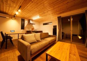 a living room with a couch and a table at Rakuten STAY HOUSE x WILL STYLE Amakusa 105 pet allowed in Kami Amakusa