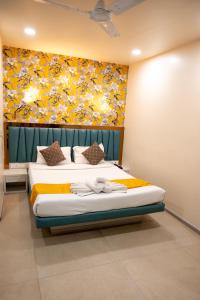 a bedroom with a bed with a painting on the wall at The Opus Kolkata - A Boutique Hotel in Kolkata