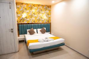 a bedroom with two beds and a painting on the wall at The Opus Kolkata - A Boutique Hotel in Kolkata