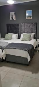 a bedroom with a large bed with a leather headboard at Ballito Hills Lifestyle Estate in Ballito