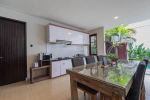 a kitchen and living room with a table and a counter at The BALIem Villa in Jimbaran