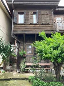 an old wooden house with a tree in front of it at Historic House in the Heart of Old Town Sozopol in Sozopol