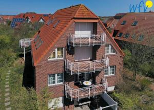 een appartementencomplex met balkons aan de zijkant bij Luv und Lee Ferienwohnung Dornbusch in Juist