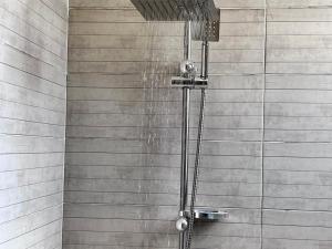 a shower with water coming out of it at Lux pyramids View Inn in Cairo