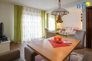 a living room with a wooden table with oranges on it at Haus Bode Ferienwohnung Bode in Borkum