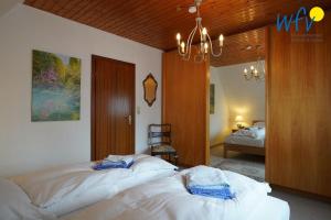 a bedroom with two beds with towels on them at Haus Bode Ferienwohnung Bode in Borkum