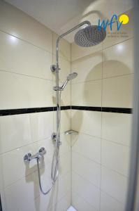 a shower with a glass door in a bathroom at Juist Zauber - Haus 3 Ferienwohnung Strandaster in Juist