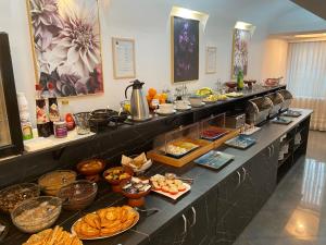 a buffet line with many different types of food at Hotel Excelsior in Timişoara