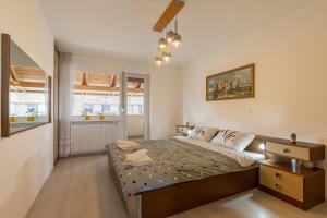 a bedroom with a bed and a desk in it at House Dijana With Pool - Happy Rentals in Nova Vas