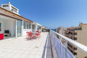 a balcony with red chairs and a view of the ocean at Superb Rooftop Roquebrune Parking in Roquebrune-Cap-Martin