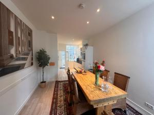 a dining room with a wooden table and chairs at Tulip House Luxury Apartment - Top Location - Rijksmuseum - Leidseplein AMSTERDAM Central 120 m2 ALL Private with kitchen in Amsterdam