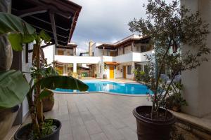 a house with a swimming pool and some plants at HOTEL PIER BODRUM MARiNA in Bodrum City