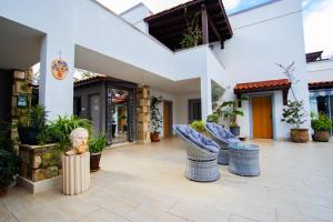 a courtyard of a house with chairs and plants at HOTEL PIER BODRUM MARiNA in Bodrum City