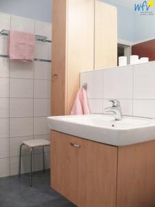 a bathroom with a sink and a pink towel at Haus Oberlin Ferienwohnung 8 in Borkum