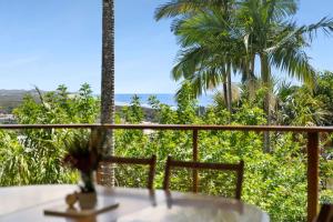a balcony with a table and a view of the ocean at TreasureView Beach - Three bedroom option #9a in Coolum Beach