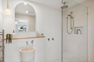 a bathroom with a glass shower with a sink at TreasureView Beach - Three bedroom option #9a in Coolum Beach +12 photos