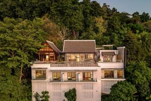 an aerial view of a house in the trees at Lada Cliff Villa Malaiwana in Nai Thon Beach